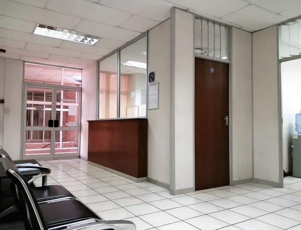 Second floor reception area seating in Loapi Business Centre Gaborone and nearby kitchen with water cooler at Loapi House